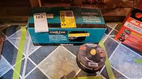 Maktec by Makita boxed angle grinder MT952 with a stack of Mastercraft metal cutting discs beside it.