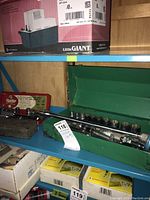 Three socket wrench sets displayed on blue metal shelving, including green metal case and red Husky case visible with ratchets and sockets.