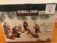 Box front showing Kirkland Signature 13-piece porcelain nativity set with nativity figures pictured