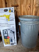 Full view of King Wash pressure washer box beside a metal garbage can with lid.