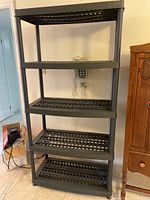Full front view of the 5-shelf resin storage unit with five ventilated resin shelves and supporting frame, placed on tiled floor indoors.