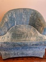 Front view of the vintage blue crushed velvet accent chair showing curved back and smooth seat with skirt.