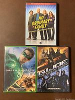Front covers of three DVD cases: No Ordinary Family Season 1, Green Lantern, and G.I. Joe The Rise of Cobra.