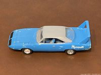 Front-side view of the blue 1970 Plymouth Superbird model car with white roof, showing overall wear
