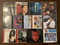 Photo showing the front covers of 14 music CDs from various artists including Michael Jackson, ABBA, Elton John, and others.