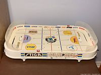 Top angled view of the entire Stiga Play-Off table hockey showing the rink design, player rod controls, and sponsor decals.