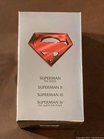 Front of the white box with red Superman logo and list of movies included in the VHS box set