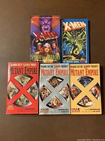 Front covers of five X-Men paperback books featuring characters and titles "Smoke and Mirrors," "The Brood Saga Part 1," and three volumes of "Mutant Empire" with red X marks on white backgrounds.