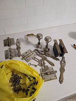Overview of all door hardware items including hinges, screws, doorknobs, lock mechanism and latch plates