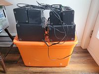 Top side view showing four satellite speakers arranged in pairs with wired connections.