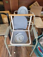 Portable commode toilet with seat lid and bucket visible
