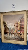 Full view of framed oil painting showing Paris street scene and Eiffel Tower