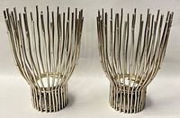 Front view of pair of silver-toned brutalist metal candleholders with vertical rod design and rounded end caps.