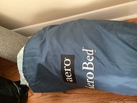 Blue AeroBed storage bag containing the inflatable mattress.