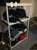 Photo showing the resin shelf loaded with bags and cases, highlighting the structure and dimensions.