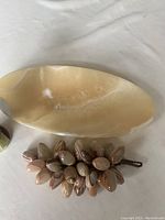 Oval marble plate with beige and off-white natural stone pattern, smooth polished surface