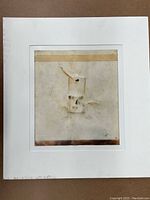 Front view of matted mixed media artwork featuring a mouse trap, showing discoloration and aging.