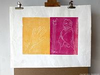 Photo of one linocut print showing two panels, left with a yellow background and outlined hand, right with magenta background and figure with covered face and crossed arms.