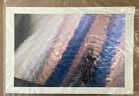 Photo of a digital photograph depicting an abstract image of a chain-link fence against sky, covered with plastic sleeve.