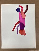 Image shows first drawing with abstract geometric shapes and colorful brush strokes using pinks, reds, and purples on white paper.