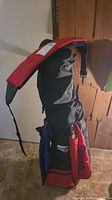 Full view of Spalding golf bag standing upright with shoulder straps and compartments visible
