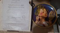 Photo of collector plate 'Making Believe at the Mirror' by Norman Rockwell with Certificate of Authenticity.