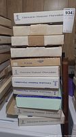 Stack of eleven Genuine Kaiser Porcelain boxes showing lot quantity and brand information