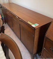 Front and side angle view showing full sideboard with two drawers and four cabinet doors