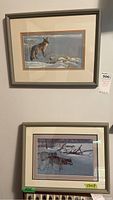 Photo showing two framed wildlife prints of foxes hanging on a wall, silver-gray frames, matted with beige and rust liners