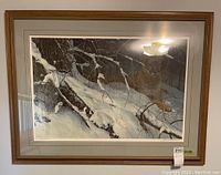 Front view of framed print depicting a cougar in a snowy forest