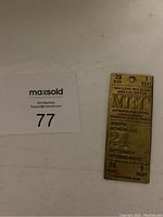 Rectangular brass ticket with engraved details of Metropolitan Opera 1973 opening night, seat 1 in box 29, dated September 24 at 8:00 PM.