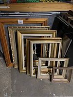 Image of seven art/picture frames of various sizes stacked inside each other, showing the different colors and decorative patterns.
