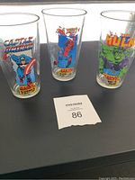 Three Marvel character glasses showing Captain America, Spider-Man, and The Hulk designs on clear drinking glasses.