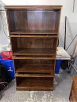 Front view of the barrister style bookcase with four glass doors and four shelves, showing interior of shelves.