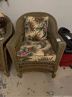 Front view of resin wicker chair with removable seat and back cushions