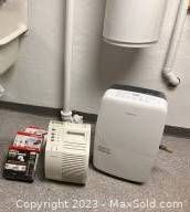 Honeywell HEPA Air Cleaner and Garrison Dehumidifier in a room near plumbing, showing scale and condition
