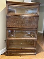 Full front view of three-section oak barrister bookcase