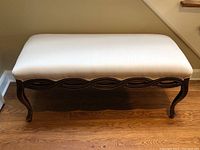 Front view of bench showing full wave apron and cabriole legs