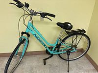 Full side view of the ladies Norco bicycle showing frame, rear rack, handlebars, saddle, and tires in light blue color.