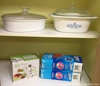 Photo showing vintage covered dishes, unopened Ziploc bag boxes, and food spiralizer on shelf