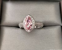 Front view of the sterling silver ring showing the marquise pink center stone surrounded by clear stones