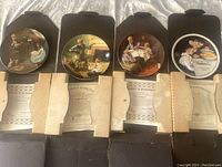 Four fine china plates from Norman Rockwell Heritage Collection in their original boxes, each featuring different artwork and titles.
