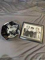 Photo showing both the framed Audrey Hepburn photo and Johnny Cash decorative plate together