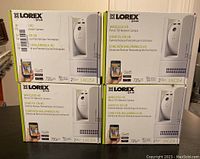Four boxed Lorex Wireless HD Pan & Tilt Network Cameras stacked with front labels showing.