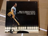 Close-up of the box cover featuring Bruce Springsteen on stage with guitar under lights.