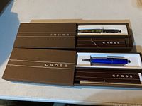 Two Cross pens in original brown boxes, showing pens and packaging