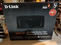 Black D-Link Amplifi HD Media Router 2000 box showing front panel and product features including USB 3.0 and HD Fuel technology.