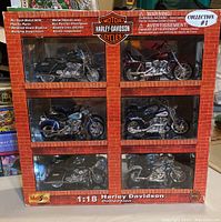Front view showing all six boxed 1:18 scale Harley Davidson diecast motorcycle models in original packaging with detailed replicates and working suspension.