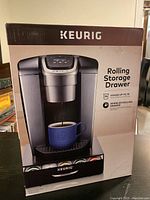 Boxed Keurig rolling storage drawer showing packaging with product image and features.
