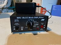 Front view of MFJ Multi-Mode DSP Filter showing model number, control knobs, switches, and LED indicators.